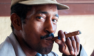 Cuban man smoking cigar.