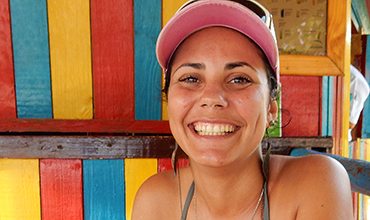 Cuban woman at beach kiosk.